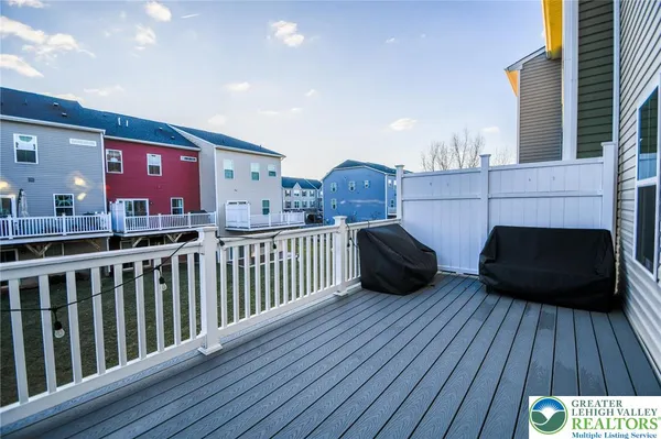 a view of a porch with wooden floor and furniture