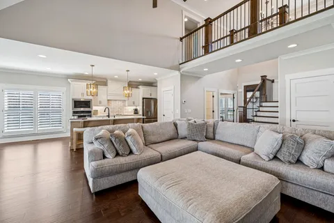 a kitchen with granite countertop a sink a counter top space stainless steel appliances and cabinets
