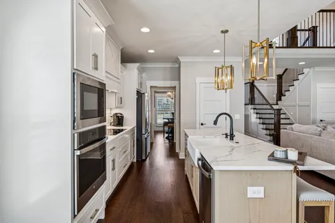 a en suite bathroom with a granite countertop sink and a mirror