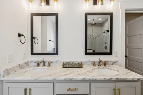 a view of a hallway with wooden floor and stairs