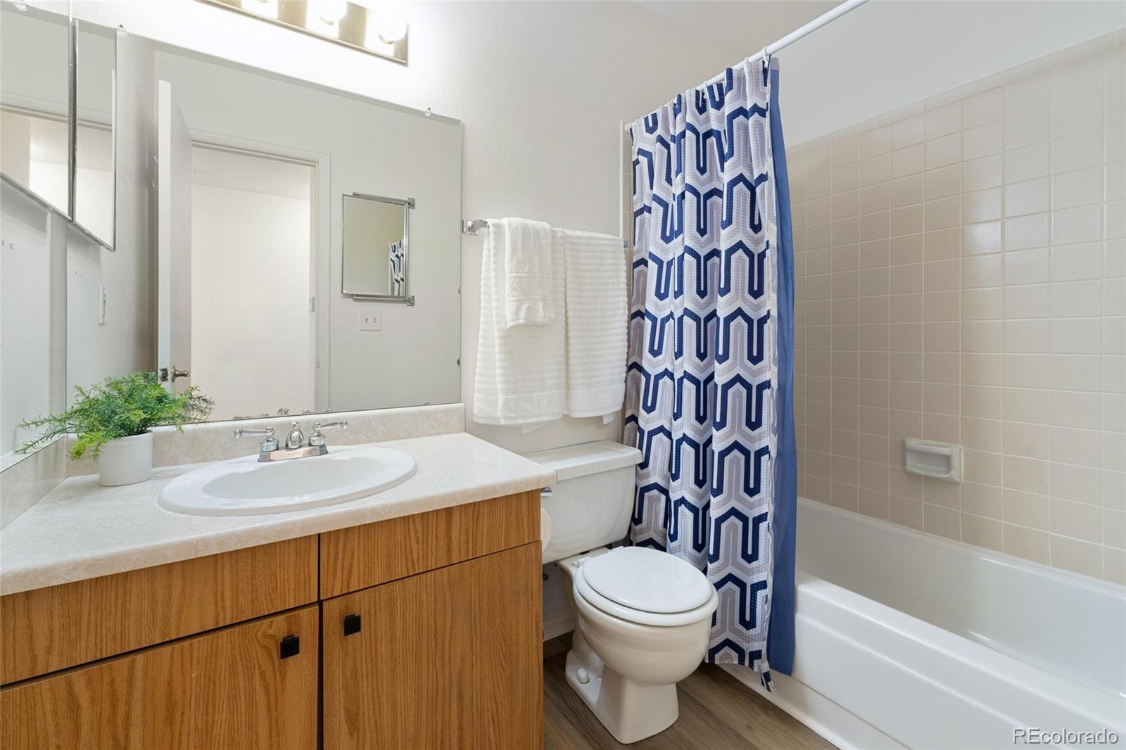 8417 Everett Way, Unit E Arvada, CO 80005 - Photo 18 of 36 a bathroom with a sink a toilet and a bathtub