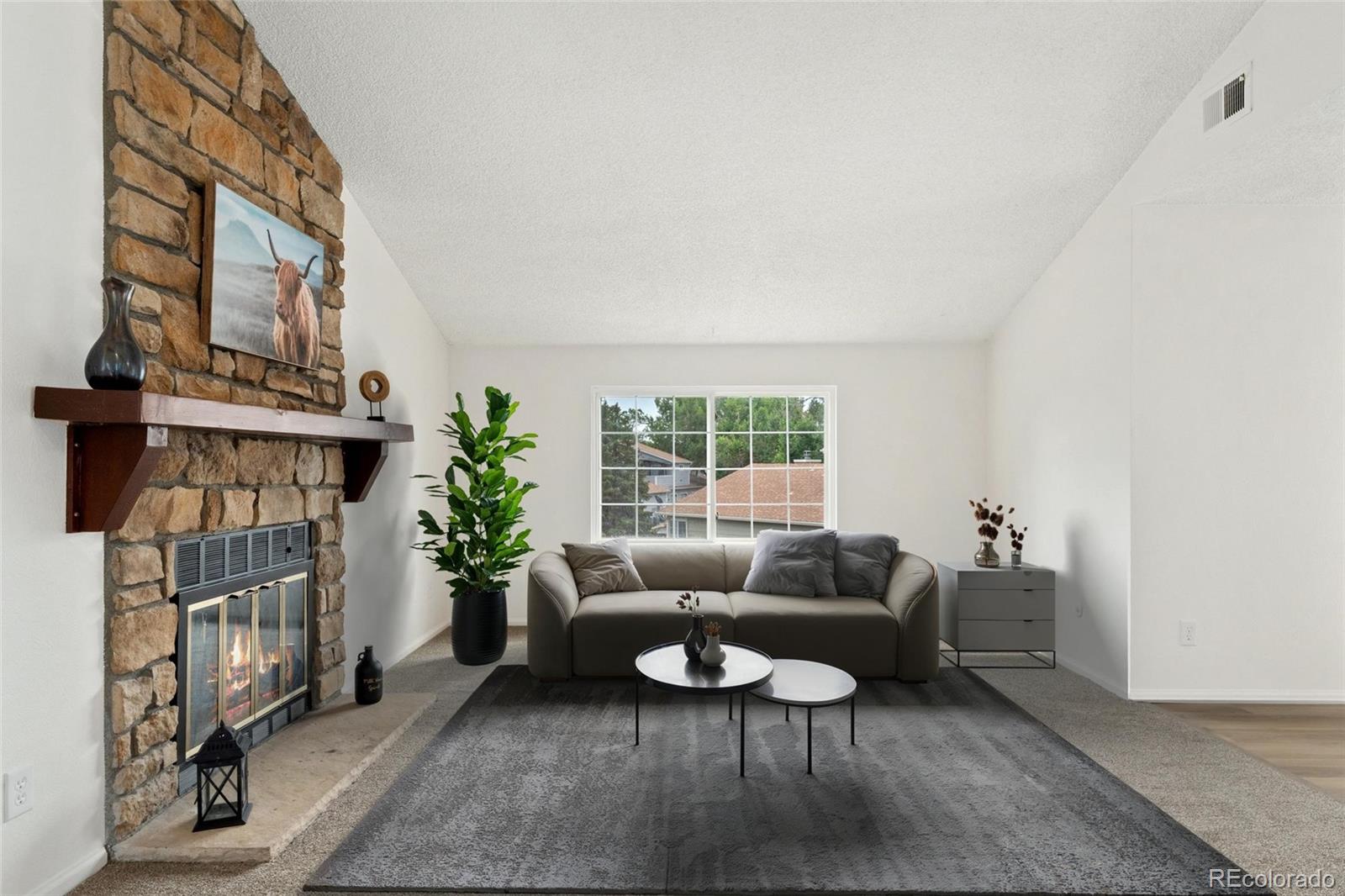 8417 Everett Way, Unit E Arvada, CO 80005 - Photo 2 of 36 a living room with furniture a fireplace and a window
