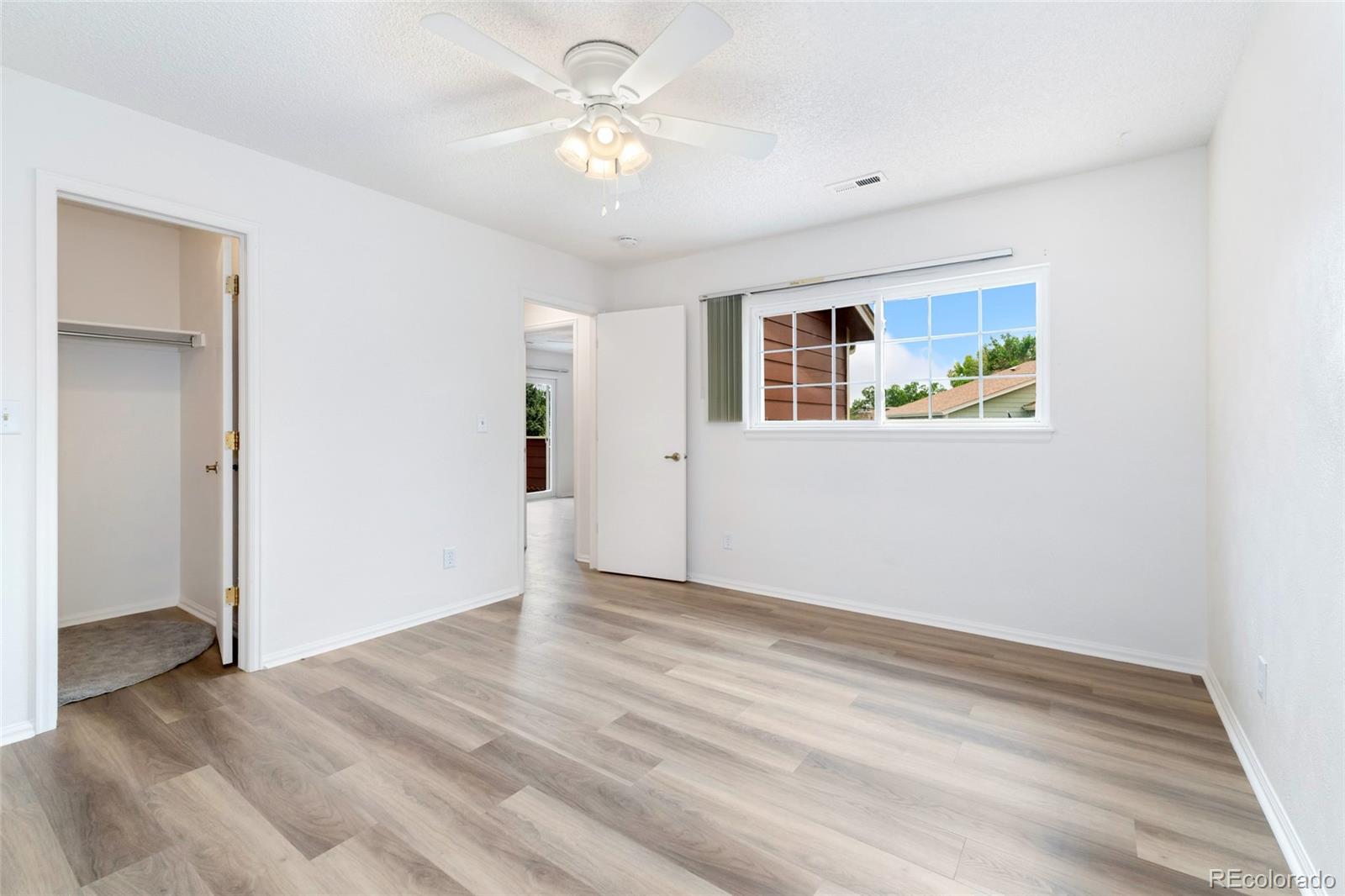 8417 Everett Way, Unit E Arvada, CO 80005 - Photo 10 of 36 a view of livingroom with hardwood floor and ceiling fan