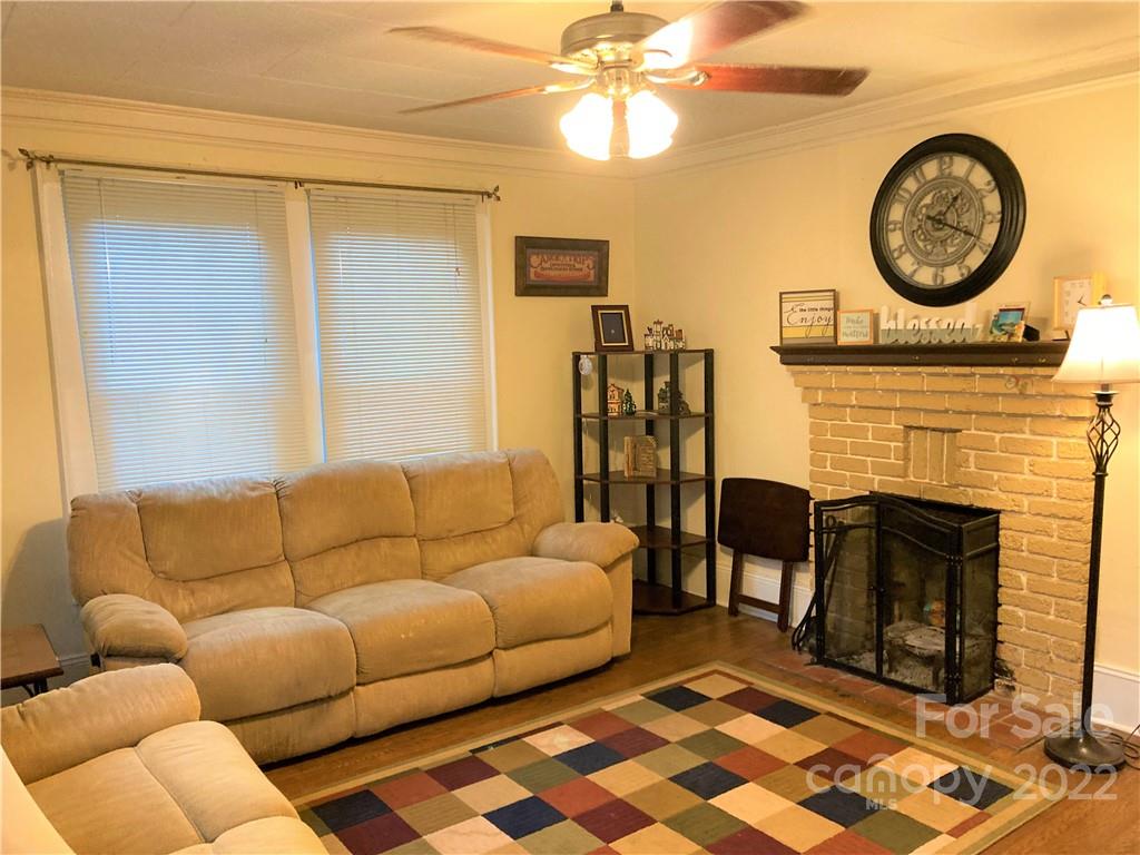 461 North Main Street Rutherfordton, NC 28139 - Photo 3 of 48 a living room with furniture a clock and a fireplace