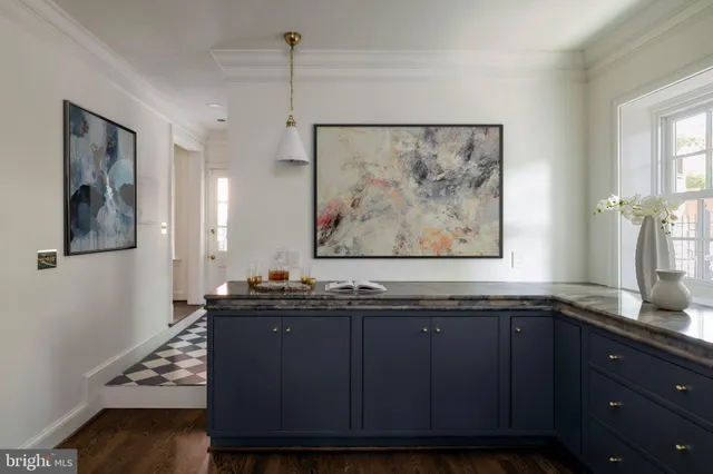 a bathroom with a granite countertop sink a large mirror and a window