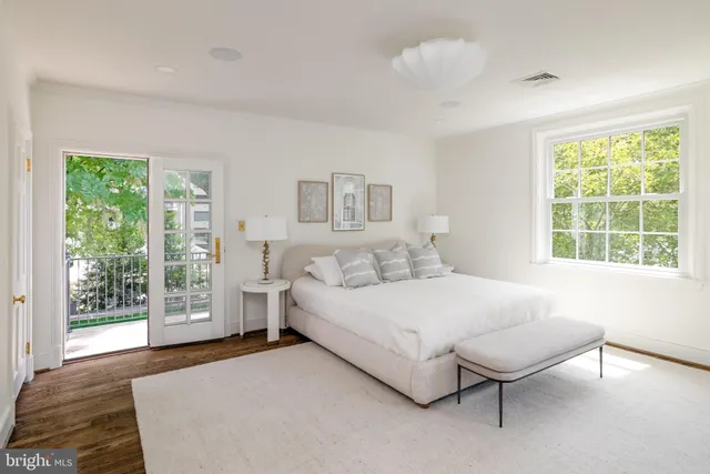 a bedroom with a bed lamp and window