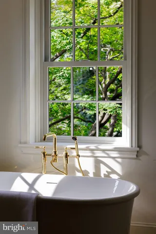 a view of a room that has a bed and a window