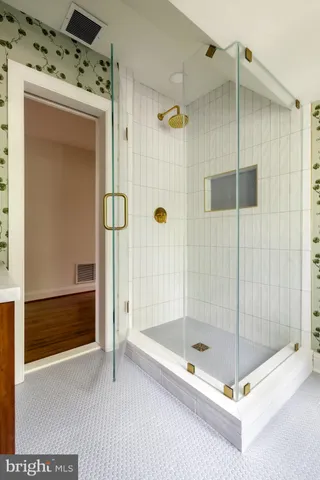 a bathroom with a shower and a glass door