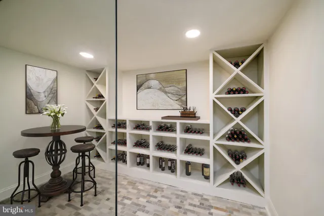 a living room with a furniture a rug and white walls