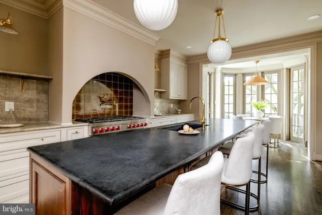 a kitchen with a table chairs and a wooden floor