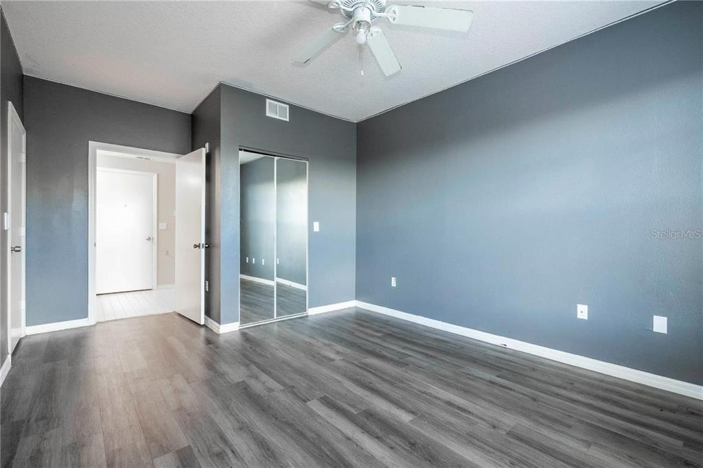 5572 Metrowest Boulevard, Unit 309 Orlando, FL 32811 - Photo 11 of 66 wooden floor in an empty room with a window