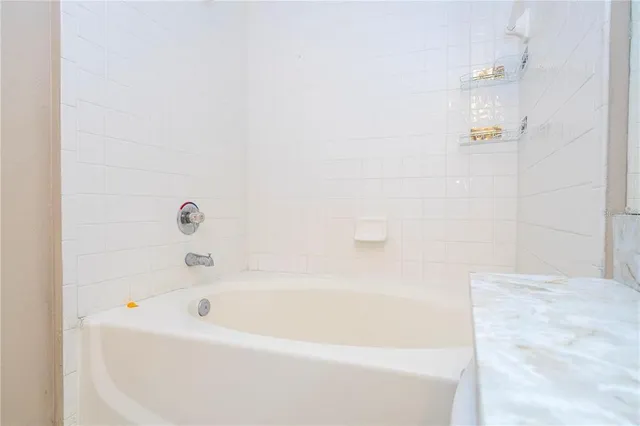 a view of walk in closet with clothes