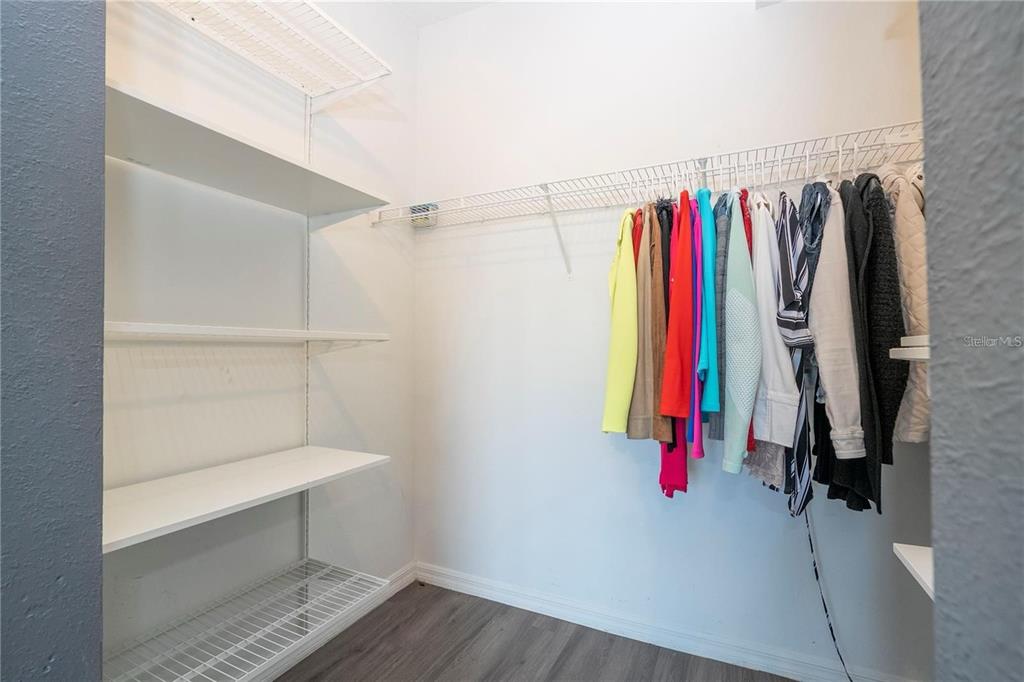 5572 Metrowest Boulevard, Unit 309 Orlando, FL 32811 - Photo 18 of 66 a view of walk in closet with clothes