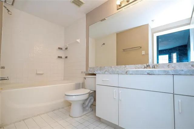a kitchen with granite countertop a sink and white cabinets