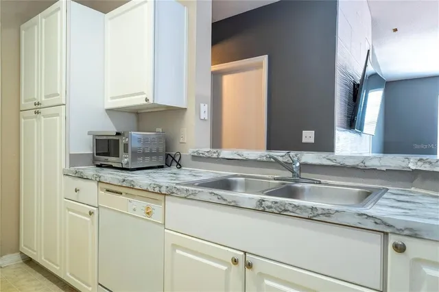 a kitchen with granite countertop a sink and a stove