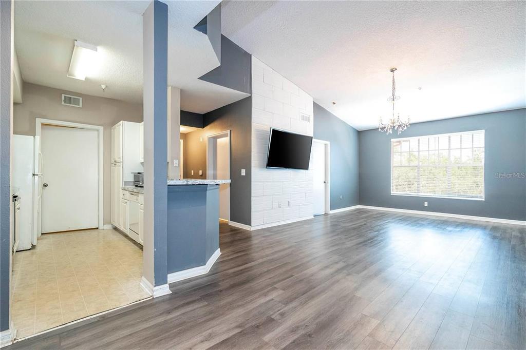 5572 Metrowest Boulevard, Unit 309 Orlando, FL 32811 - Photo 30 of 66 an empty room with wooden floor and windows