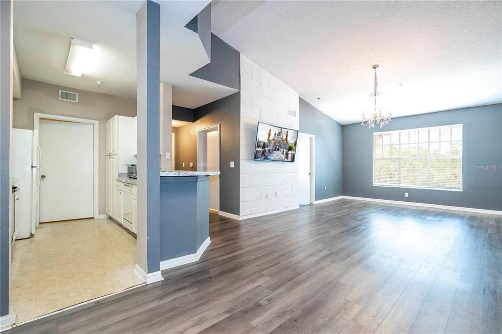 5572 Metrowest Boulevard, Unit 309 Orlando, FL 32811 - Photo 31 of 66 an empty room with wooden floor and windows