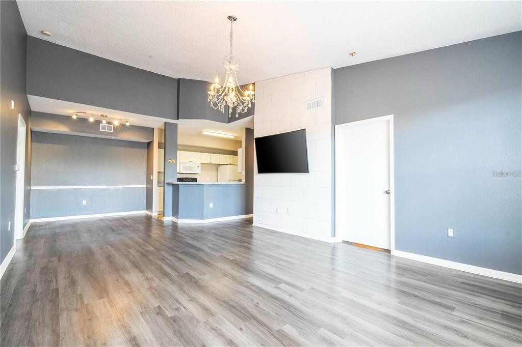 5572 Metrowest Boulevard, Unit 309 Orlando, FL 32811 - Photo 41 of 66 a view of a kitchen with a microwave and wooden floor