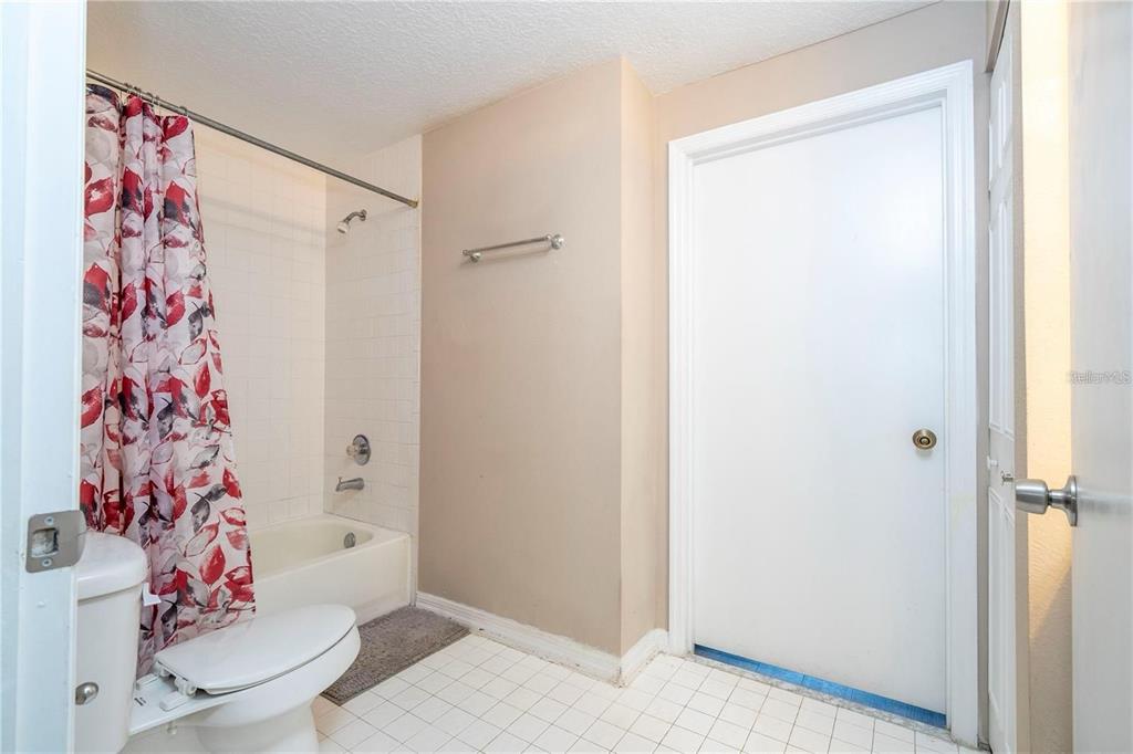 5572 Metrowest Boulevard, Unit 309 Orlando, FL 32811 - Photo 43 of 66 a bathroom with a shower and a toilet