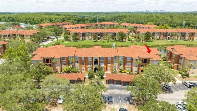 an aerial view of residential houses with outdoor space and swimming pool