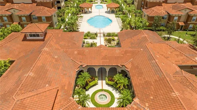 an aerial view of a house with outdoor space lake view and mountain view