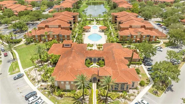 an aerial view of a house with outdoor space lake view and mountain view