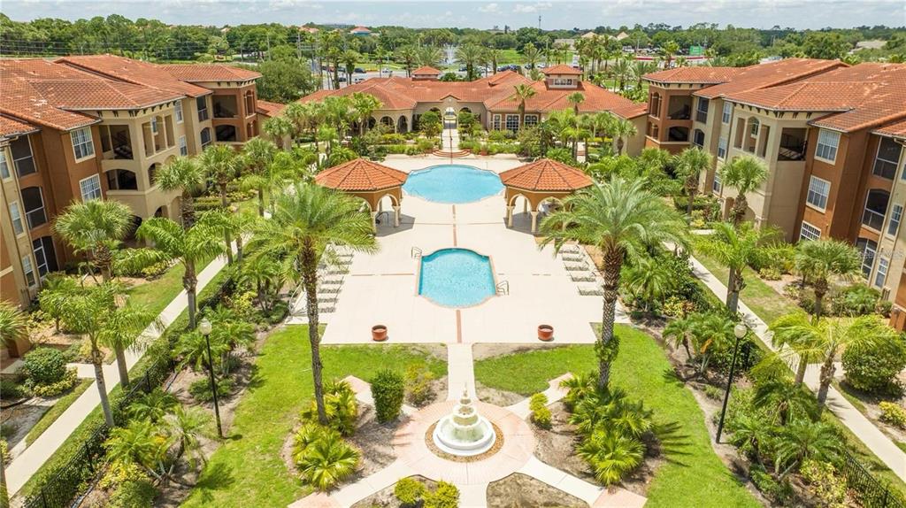 5572 Metrowest Boulevard, Unit 309 Orlando, FL 32811 - Photo 57 of 66 a view of a city with lawn chairs under an umbrella
