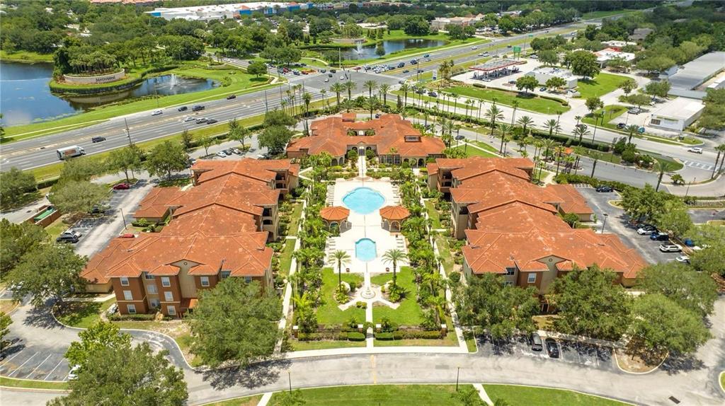 5572 Metrowest Boulevard, Unit 309 Orlando, FL 32811 - Photo 59 of 66 an aerial view of residential houses with outdoor space and street view