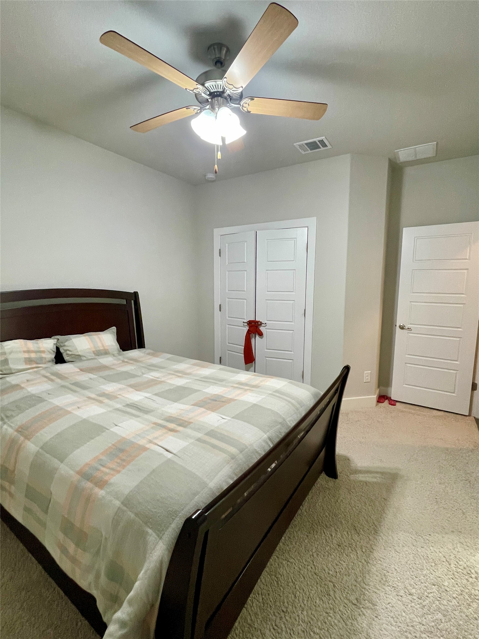 120 Sail Wind Way Georgetown, TX 78633 - Photo 19 of 25 a bedroom with a bed and a chandelier