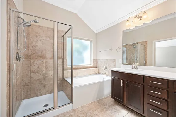 a bathroom with a bathtub shower sink mirror and toilet