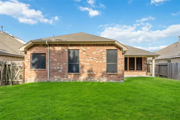a front view of house with a garden