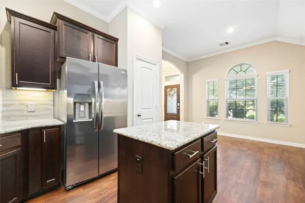 a kitchen with a cabinet a sink and a refrigerator
