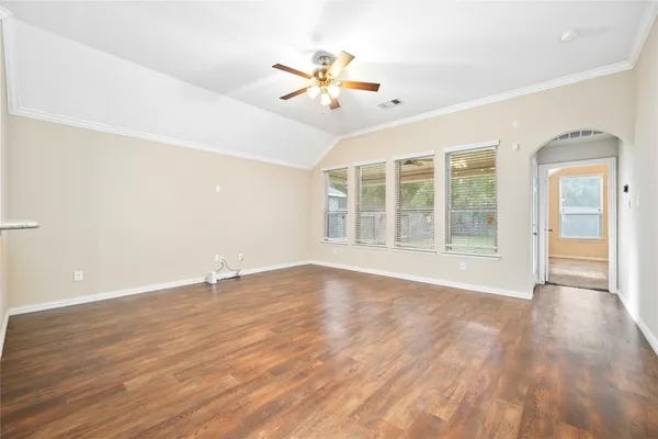 wooden floor in an empty room with a window
