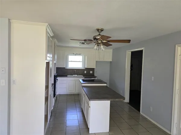 a view of a kitchen with a sink cabinets and a window
