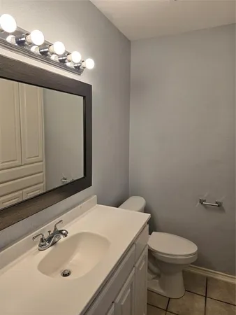 a bathroom with a sink a toilet and mirror