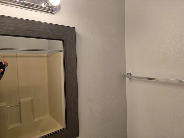 a bathroom with a glass door shower