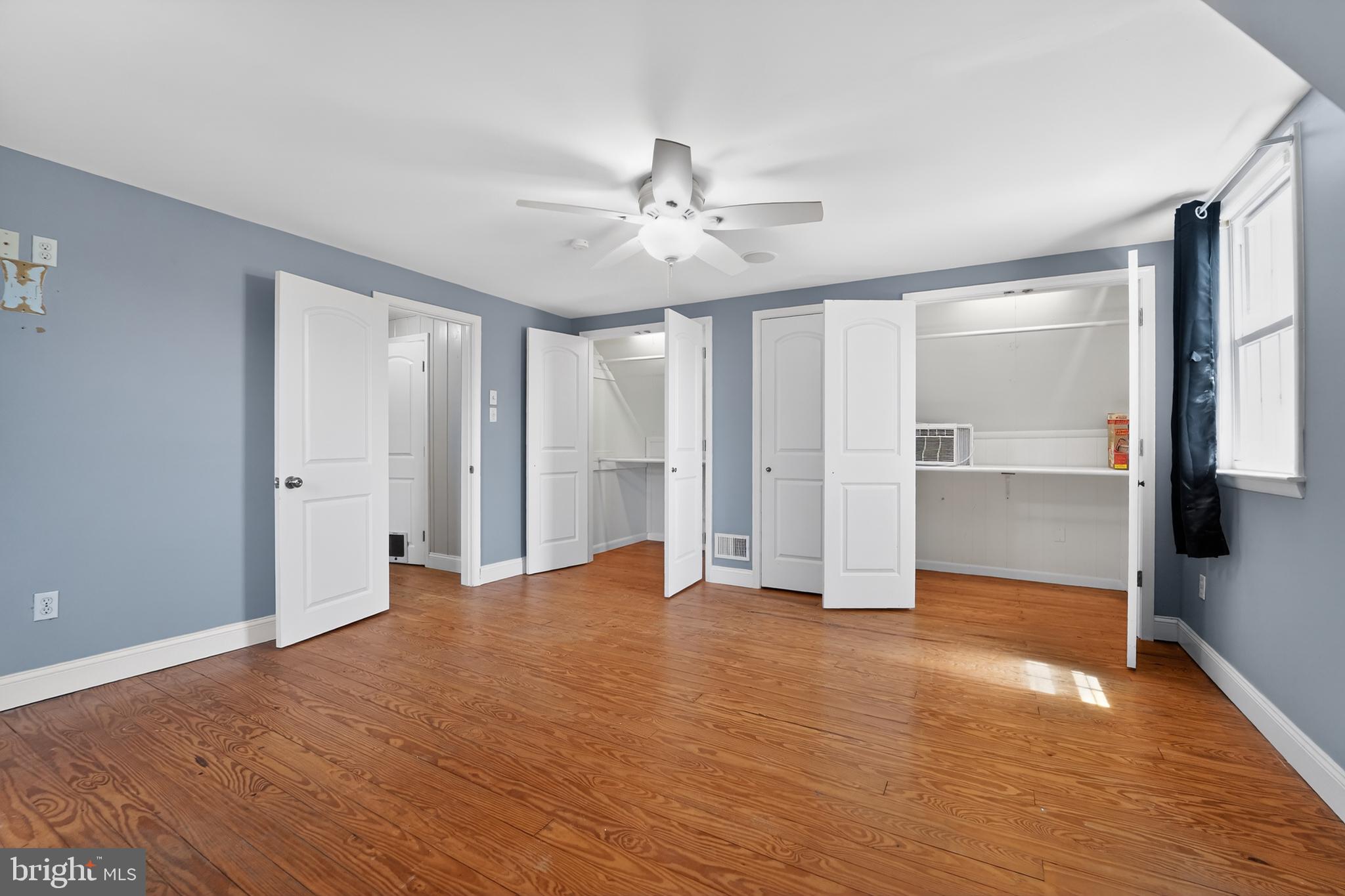 9408 Dana Vista Road Baltimore, MD 21236 - Photo 26 of 38 a view of an empty room with wooden floor and a ceiling fan