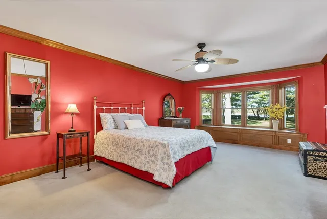 a spacious bedroom with a bed and a chandelier
