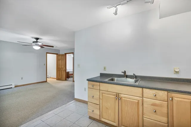 a bathroom with a granite countertop sink a mirror and vanity
