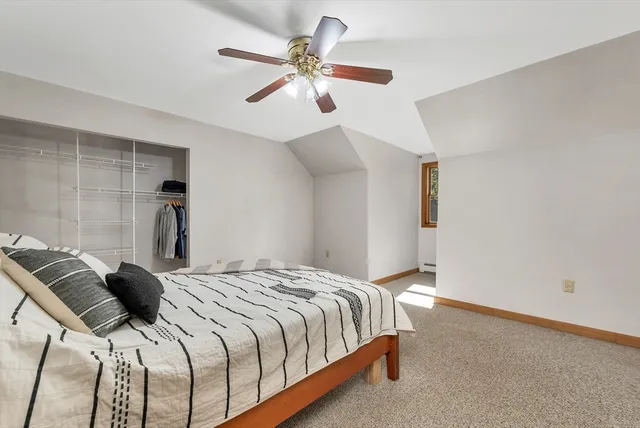 a bedroom with a bed and a ceiling fan