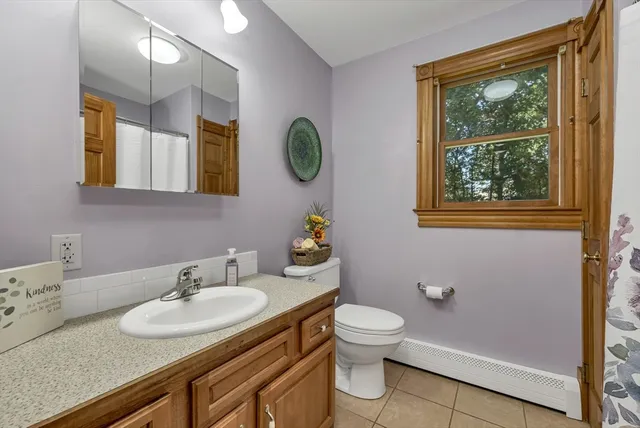 a bathroom with a sink vanity and a mirror