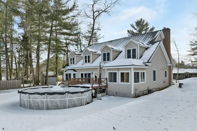a front view of a house with a yard and fountain