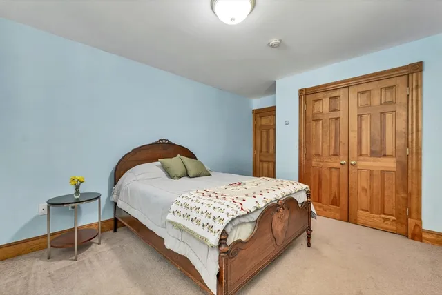 a bedroom with a bed and a table