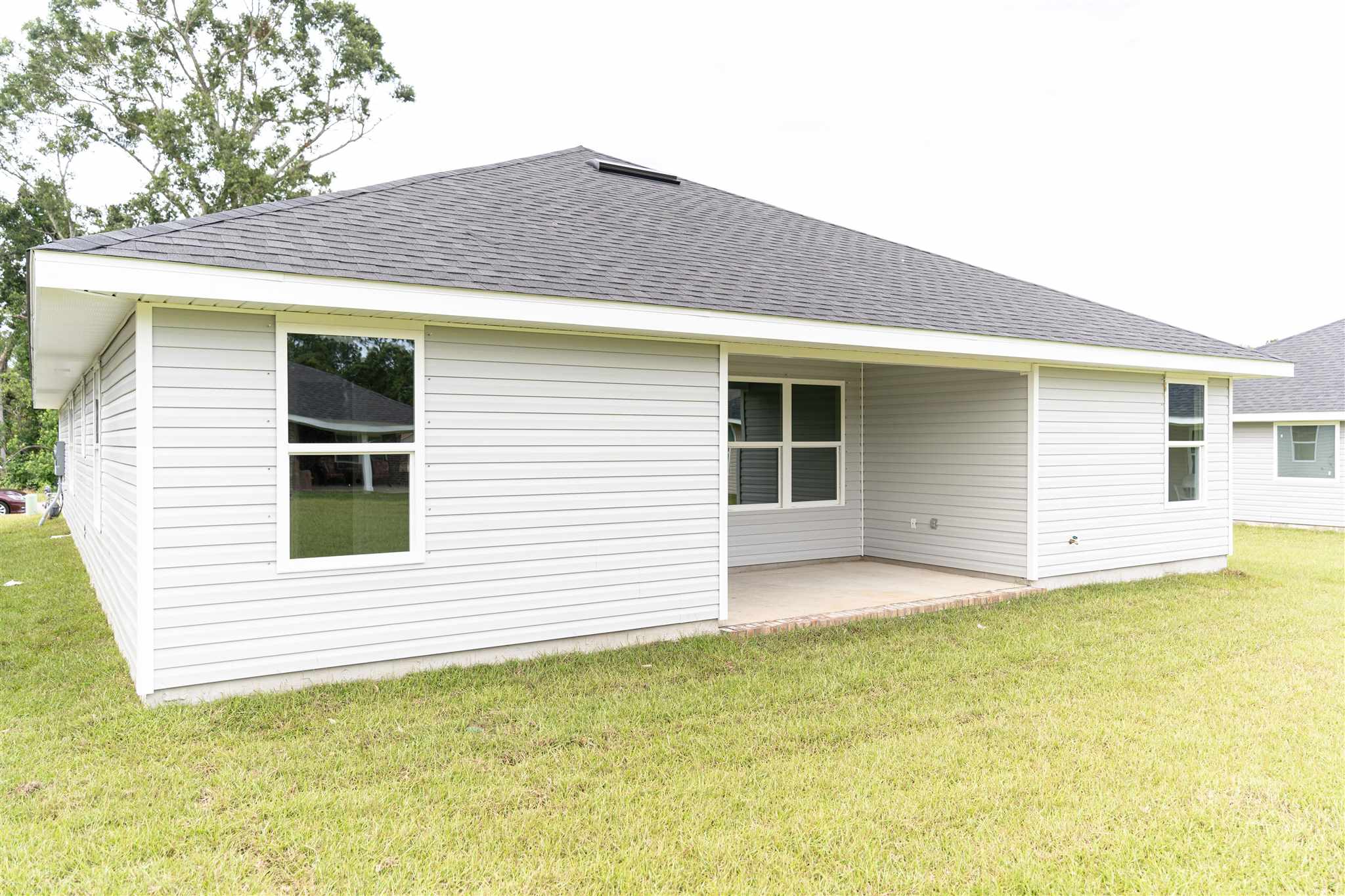 1813 Leigh Loop Cantonment, FL 32533 - Photo 14 of 15 a view of a house with a yard and garage