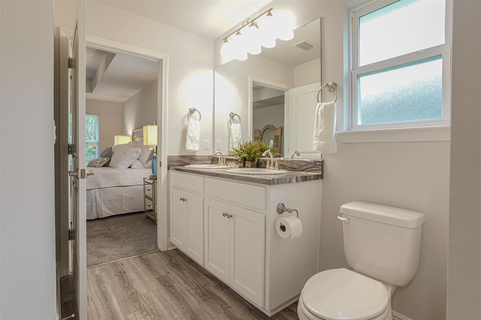 1813 Leigh Loop Cantonment, FL 32533 - Photo 9 of 15 a bathroom with a toilet a sink and mirror