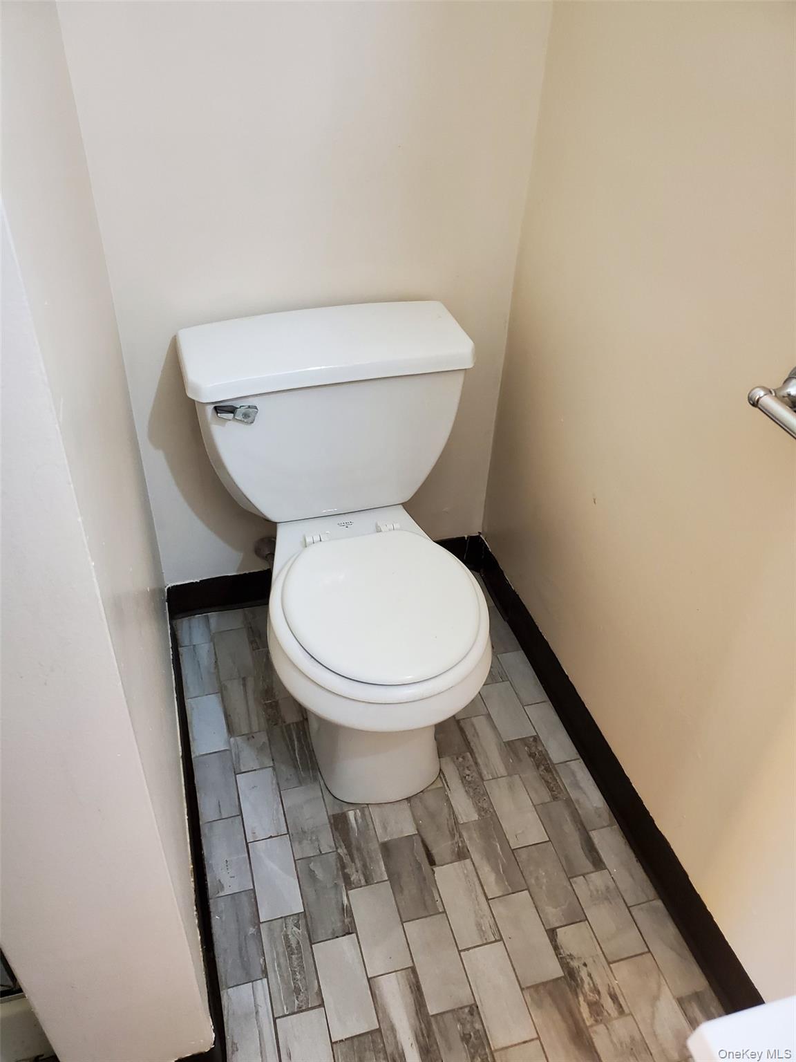 75 Pipetown Hill Road Nanuet, NY 10954 - Photo 11 of 14 a white toilet sitting next to a white wall