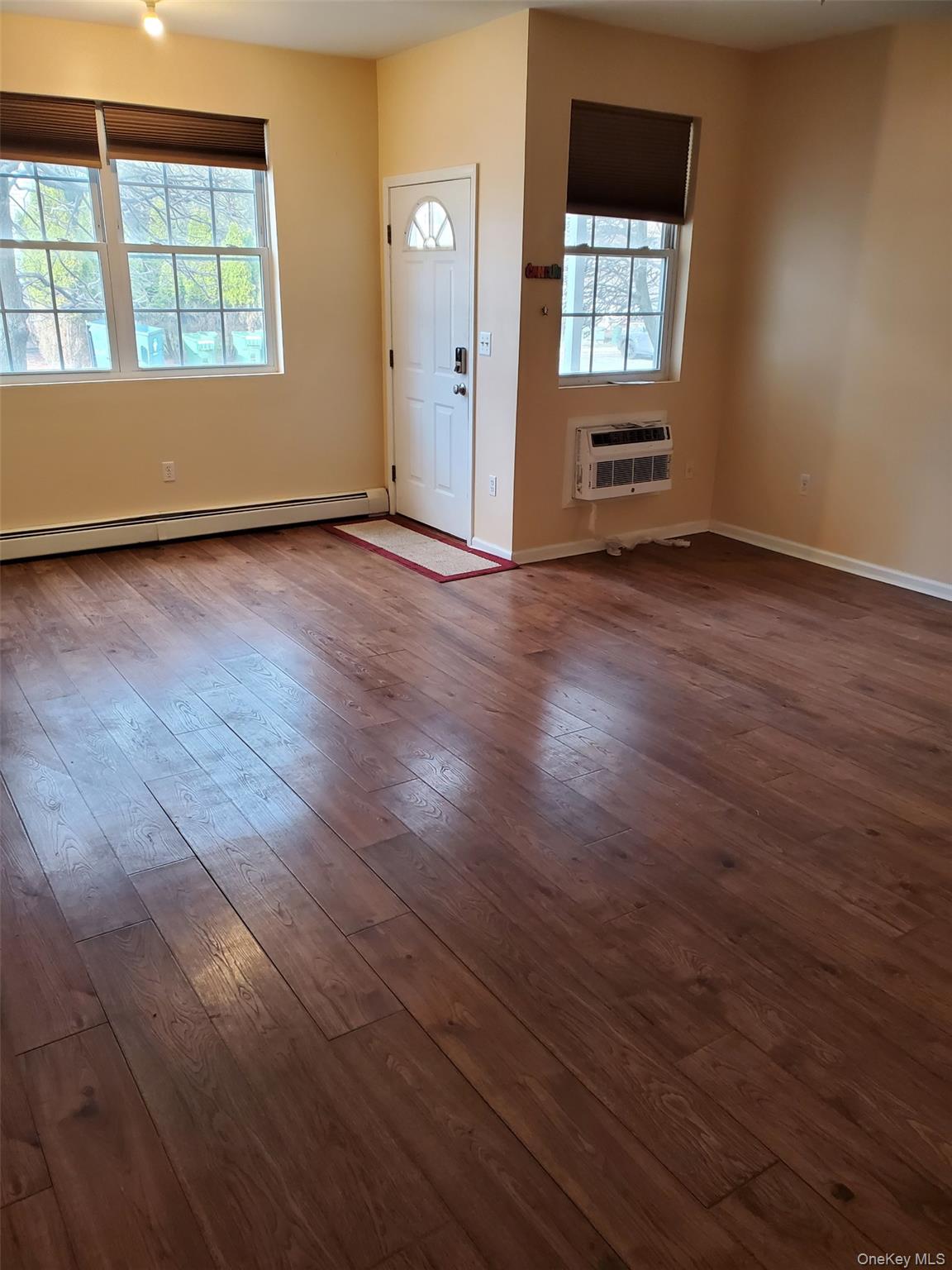 75 Pipetown Hill Road Nanuet, NY 10954 - Photo 3 of 14 an empty room with wooden floor and windows