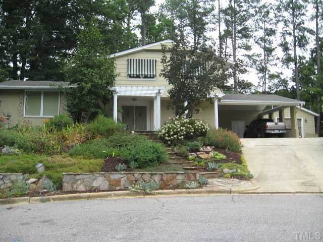 1200 Mindees Court Raleigh, NC 27609 - Photo 1 of 11 front view of house with a yard and potted plants