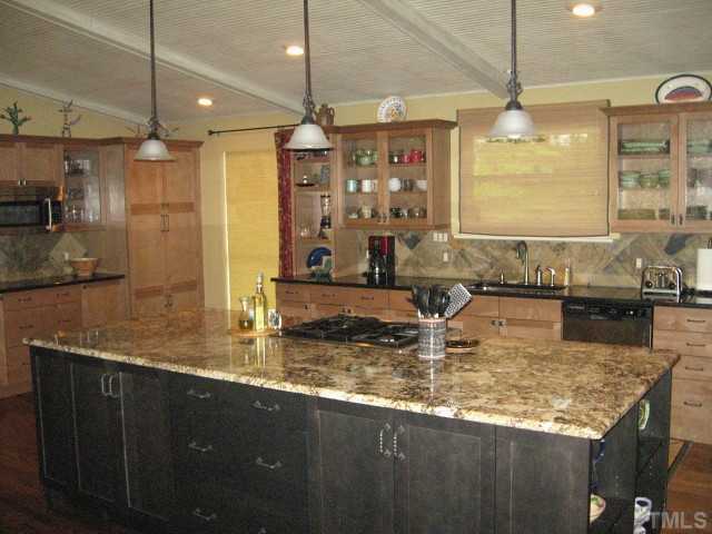 1200 Mindees Court Raleigh, NC 27609 - Photo 2 of 11 a kitchen with kitchen island granite countertop a sink a counter top space and cabinets