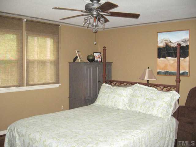 1200 Mindees Court Raleigh, NC 27609 - Photo 5 of 11 a bedroom with a bed and a window